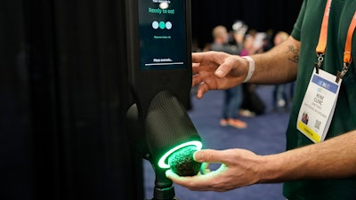 An exhibitor demonstrates the OneThird avocado ripeness checker during CES Unveiled before the start of the CES tech show, Tuesday, Jan. 3, 2023, in Las Vegas.