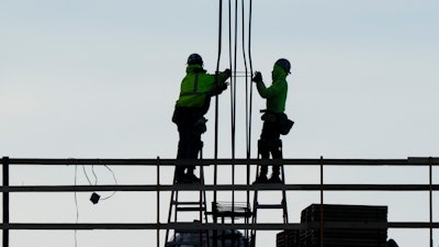 Construction workers on a building in Philadelphia, Dec. 21, 2022.