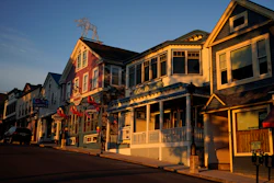 Early-morning light shines on shops in Bar Harbor, Maine, June 11, 2022.