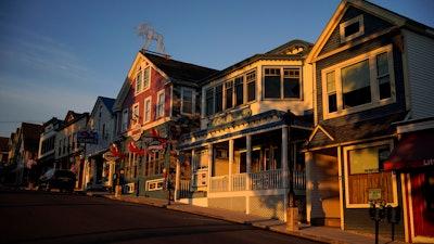 Early-morning light shines on shops in Bar Harbor, Maine, June 11, 2022.