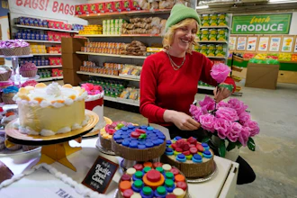 Robin Frohardt, creator of the Plastic Bag Store, holds plastic bag roses at the art installation, Jan. 17, 2023, Ann Arbor, Mich.