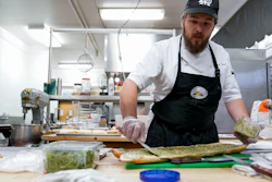 Chef Josh Gjersand prepares a sandwich for Mount Diablo High School students to try during a taste test in Concord, Calif., Jan. 13, 2023.