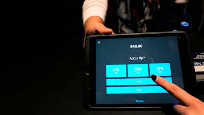 A tipping option displayed on a card reader tablet at X-Golf indoor golf in Glenview, Ill., Jan. 10, 2023.
