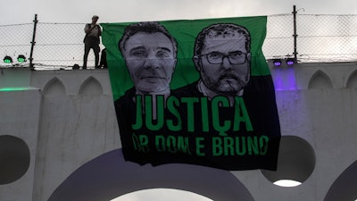 A sign that reads 'Justice for Dom and Bruno' is displayed on the Arcos da Lapa aqueduct, Rio de Janeiro, June 26, 2022.