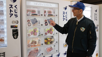 Konomu Kubo, a spokesperson for Kyodo Senpaku Co., explains how whale meat is being sold from a vending machine, Yokohama, Japan, Jan. 26, 2023.