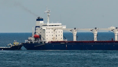 A boat with Russian, Ukrainian, Turkish and U.N. officials heads to the Sierra Leone-flagged cargo ship Razoni off the coast of Istanbul, Aug. 3, 2022.