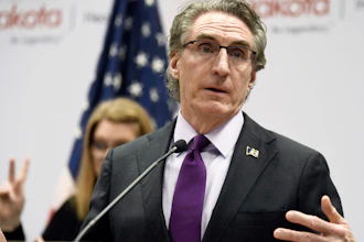 North Dakota Gov. Doug Burgum speaks at the state Capitol in Bismarck, April 10, 2020.
