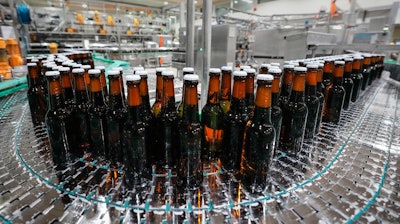 Beer bottles are filled at the Veltins beer brewery in Meschede, Germany, Aug. 24, 2022.