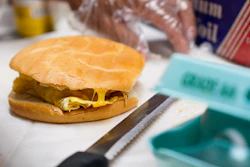 Hector Perez prepares to wrap a bacon, egg and cheese sandwich at a bodega in the Bronx, New York, July 22, 2022.