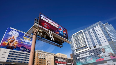 Advertisements adorn buildings and electronic billboards leading up to Super Bowl LVII in Phoenix, Feb. 3, 2023.