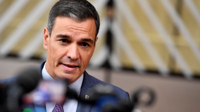 Spanish Prime Minister Pedro Sanchez speaks with the media as he arrives for an EU summit in Brussels, Oct. 20, 2022.