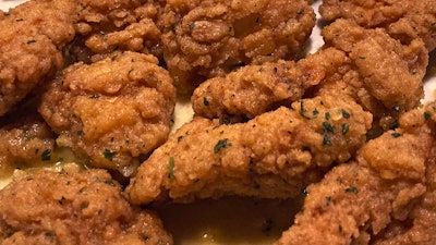 An order of 'boneless chicken wings' rests on a plate, Tuesday, Feb. 7, 2023, in Derry, N.H.