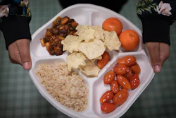 A seventh grader carries her plate during her lunch break at a local public school, Brooklyn, New York, Feb. 10, 2023.