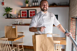 Matt Baker, chef and owner of Gravitas, poses inside the restaurant in Washington, Feb. 14, 2023.