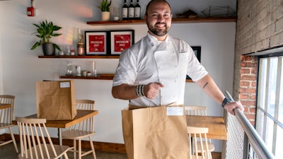Matt Baker, chef and owner of Gravitas, poses inside the restaurant in Washington, Feb. 14, 2023.