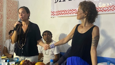 Beatriz Matos, widow of Indigenous expert Bruno Pereira, left, and Alessandra Sampaio, widow of British journalist Dom Phillips, attend a ceremony in Atalaia do Norte, Brazil, Feb. 27, 2023.