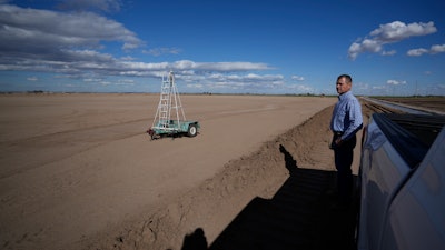 Tom Brundy looks over a field in preparation for planting at his farm near Calexico, Calif., Feb. 28, 2023.