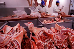 Butchers prepare cuts of meat at Smithfield Market in London, July 18, 2016.