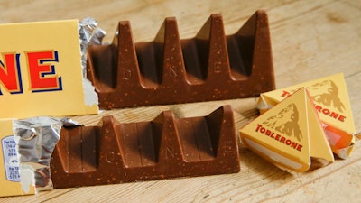 Two bars of the Toblerone Swiss chocolate are shown, at front is the new style 150 gram bar showing the reduction in triangular pieces, in the background is the older style 360 gram bar, pictured in London, on Nov. 8, 2016.