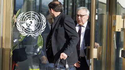 Russia's Deputy Foreign Minister Sergei Vershinin, right, leaves the European headquarters of the United Nations in Geneva, Switzerland, March 13, 2023.