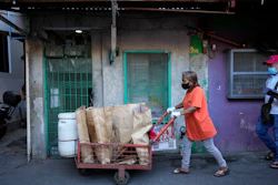 Marilene Capentes pushes her cart along the streets of Malabon, Philippines, Feb. 13, 2023.
