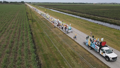 Farmworkers and allies march through agricultural land in Pahokee, Fla., March 14, 2023.