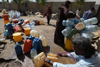 People get drinking water from a water collecting point in Karachi, Pakistan, March 21, 2023.