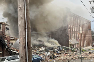 Emergency personnel work at the site of a deadly explosion at a chocolate factory in West Reading, Pa., March 24, 2023.