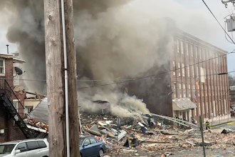 Emergency personnel work at the site of a deadly explosion at a chocolate factory in West Reading, Pa., Friday, March 24, 2023.