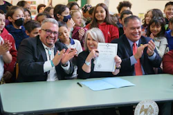 New Mexico Gov. Michelle Lujan Grisham holds a bill signed at Pinon Elementary School in Santa Fe, N.M., March 27, 2023.