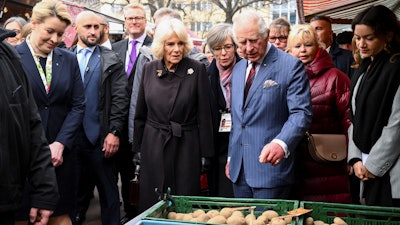 Berlin Mayor Franziska Giffey, Britain's King Charles and Camilla the Queen Consort visit a farmer's market on Wittenbergplatz square, Berlin, March 30, 2023.