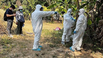 Health experts spray disinfectant at a village in Prey Veng, Cambodia, Feb. 24, 2023.