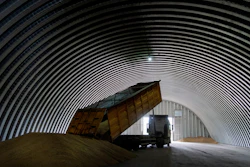 A dump track unloads grain in a granary, Zghurivka, Ukraine, Aug. 9, 2022.