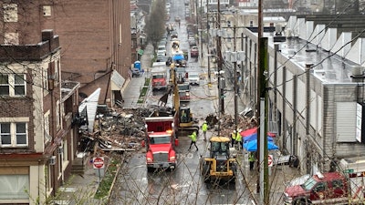 Emergency responders and heavy equipment at the site of a deadly explosion at a chocolate factory in West Reading, Pennsylvania, March 25, 2023.