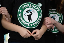 Starbucks employees and supporters react as votes are read during a union-election watch party in Buffalo, N.Y., Dec. 9, 2021.