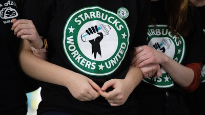 Starbucks employees and supporters react as votes are read during a union-election watch party in Buffalo, N.Y., Dec. 9, 2021.