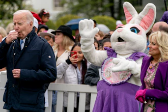 President Joe Biden, accompanied by first lady Jill Biden, blows his whistle for the start of a race during the White House Easter Egg Roll, April 18, 2022, Washington.