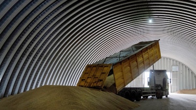 A track unloads grain in a granary, Zghurivka, Ukraine, Aug. 9, 2022.