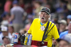 A beer vendor walks through the stands during the seventh inning of a game between the Arizona Diamondbacks and the Milwaukee Brewers, Phoenix, April 11, 2023.