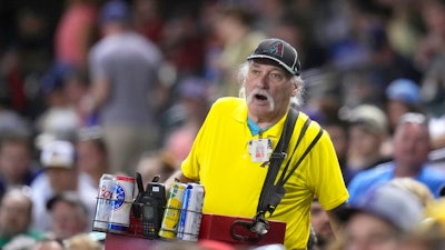A beer vendor walks through the stands during the seventh inning of a game between the Arizona Diamondbacks and the Milwaukee Brewers, Phoenix, April 11, 2023.