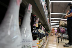 A customer looks at beer on shelves at a supermarket in Bangkok, April 24, 2023.
