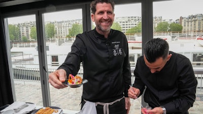 Alexandre Mazzia, chef at AM in Marseille, presents his herbaceous chickpea pomade dish during a press conference in Paris, May 9, 2023.