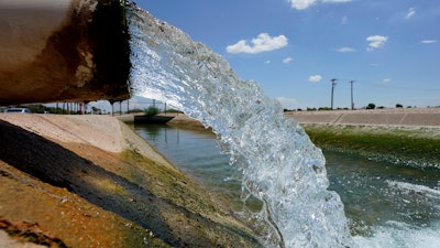 Water from the Colorado River diverted through the Central Arizona Project fills an irrigation canal in Maricopa, Aug. 18, 2022.