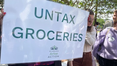 Proponents of removing a tax on groceries hold a rally outside the statehouse in Montgomery, Ala., April 11, 2023.