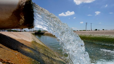Water from the Colorado River diverted through the Central Arizona Project fills an irrigation canal, Maricopa, Ariz., Aug. 18, 2022.