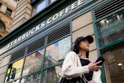 Pedestrians pass a Starbucks in Lower Manhattan, June 13, 2023.