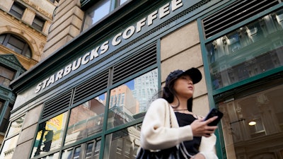 Pedestrians pass a Starbucks in Lower Manhattan, June 13, 2023.