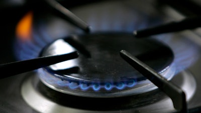 A gas-lit flame burns on a natural gas stove, Jan. 11, 2006.