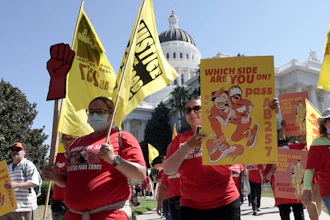 Fast food workers and their supporters march past the California state Capitol in Sacramento, Aug. 16, 2022.