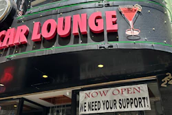 A banner asking for support hangs outside the Sam's Cable Car Lounge near Union Square, San Francisco, June 21, 2023.
